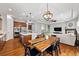 Open-concept living space with kitchen island, dining area, and a living room with a fireplace at 14134 Glenayre Cir, Parker, CO 80134