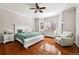 Spacious main bedroom featuring a bay window, ceiling fan and hardwood floors at 14134 Glenayre Cir, Parker, CO 80134
