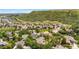 Aerial view showcasing the neighborhood with mountain backdrop, trees, and well-maintained homes at 276 Ember Pl, Castle Rock, CO 80104