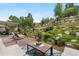 Spacious backyard with an inviting patio, lush landscaping, and a serene waterfall feature at 276 Ember Pl, Castle Rock, CO 80104