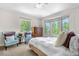 Serene bedroom with large windows, plush carpet, and comfortable seating area at 276 Ember Pl, Castle Rock, CO 80104