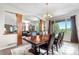 Open-concept dining area with a spacious wooden table and expansive windows offering scenic views at 276 Ember Pl, Castle Rock, CO 80104