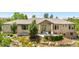Exterior of a ranch-style home featuring manicured landscaping, a stone-accented facade, and a welcoming front entrance at 276 Ember Pl, Castle Rock, CO 80104