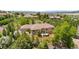 Stunning home with lush landscaping, mature trees, and elegant stone accents on a sprawling lot at 276 Ember Pl, Castle Rock, CO 80104