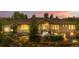 Charming home with well-lit exterior, stone-accented garden beds and inviting entryway at 276 Ember Pl, Castle Rock, CO 80104