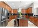 Gourmet kitchen with rich wood cabinetry, stainless steel appliances, and a functional island with seating at 276 Ember Pl, Castle Rock, CO 80104
