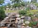 Picturesque rock garden with a cascading waterfall and lush greenery, enhancing the natural beauty at 276 Ember Pl, Castle Rock, CO 80104