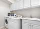 Laundry room with white cabinetry, washer, dryer and sink at 276 Ember Pl, Castle Rock, CO 80104
