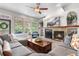 Inviting living room with a cozy fireplace, plush sectional sofa, and serene backyard views at 276 Ember Pl, Castle Rock, CO 80104