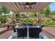 Outdoor dining area featuring a pergola and a lush backyard setting at 276 Ember Pl, Castle Rock, CO 80104