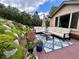 Inviting patio seating area featuring a sectional sofa with a patterned rug, set amongst lush landscaping at 276 Ember Pl, Castle Rock, CO 80104