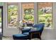 Cozy sitting area with a comfortable blue chair and a scenic view of the landscaped backyard at 276 Ember Pl, Castle Rock, CO 80104