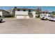 Exterior shot of building with two car garages, an exterior balcony, and parking lot in front at 3351 S Field St # 164, Lakewood, CO 80227