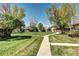 Exterior shot of building with grassy area and walkway at 3351 S Field St # 164, Lakewood, CO 80227