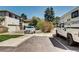 Exterior of building with driveway and parked vehicles and landscaping at 3351 S Field St # 164, Lakewood, CO 80227