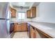 A full view of the cozy kitchen featuring wood cabinets and stainless steel appliances at 3351 S Field St # 164, Lakewood, CO 80227
