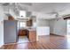 A full view of the cozy kitchen and open floorplan featuring wood cabinets and stainless steel refrigerator at 3351 S Field St # 164, Lakewood, CO 80227
