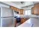 Kitchen with stainless steel appliances, light wood cabinetry, and bright lighting at 3351 S Field St # 164, Lakewood, CO 80227
