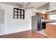 Cozy living area with wood floors, ceiling fan, and an open view to the adjacent kitchen at 3351 S Field St # 164, Lakewood, CO 80227