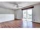 Bright and inviting living room featuring wood floors, a ceiling fan, and access to a deck at 3351 S Field St # 164, Lakewood, CO 80227