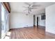 Bright living room featuring wood floors, a ceiling fan, and sliding glass doors to a deck at 3351 S Field St # 164, Lakewood, CO 80227