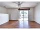 Bright living room with wood floors, ceiling fan and sliding glass doors to a private balcony at 3351 S Field St # 164, Lakewood, CO 80227