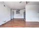 Open-concept living area boasts wood floors, a ceiling fan, and view to the kitchen at 3351 S Field St # 164, Lakewood, CO 80227