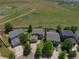 View of a yellow house surrounded by green lawns and trees; mountains in the distance at 828 Lehigh Cir, Erie, CO 80516