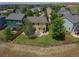 Aerial view of a fenced backyard featuring a patio and lush greenery at 828 Lehigh Cir, Erie, CO 80516