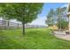 Large, fenced backyard featuring a stone patio and grassy area perfect for outdoor entertaining at 828 Lehigh Cir, Erie, CO 80516