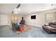 Finished basement with two windows, a sofa, two armchairs and a TV at 828 Lehigh Cir, Erie, CO 80516