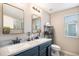 Bright bathroom features double sinks with modern fixtures and ample counter space at 828 Lehigh Cir, Erie, CO 80516