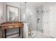 Bathroom boasts walk-in glass shower with sleek fixtures next to vintage vanity at 828 Lehigh Cir, Erie, CO 80516