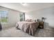 Serene bedroom with soft carpeting, large windows, and a comfortable bed at 828 Lehigh Cir, Erie, CO 80516