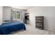 A bright bedroom featuring a window, queen bed, and dresser at 828 Lehigh Cir, Erie, CO 80516
