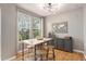 Stylish dining room featuring modern light fixture, large windows, and decorative world map art at 828 Lehigh Cir, Erie, CO 80516