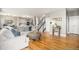 Open-concept living area featuring hardwood floors and seamlessly connecting to the kitchen and dining areas at 828 Lehigh Cir, Erie, CO 80516
