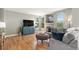 Comfortable living room with hardwood floors, large windows, and stylish decor at 828 Lehigh Cir, Erie, CO 80516