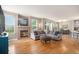 Spacious living room with a cozy fireplace, hardwood floors, and ample natural light at 828 Lehigh Cir, Erie, CO 80516