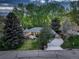 Areal shot of a home that features a lush lawn, mature tree coverage, and large driveway at 2635 S Lamar Way, Lakewood, CO 80227