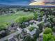 Aerial shot of a quiet neighborhood with lush greenery and the vibrant colors of sunset at 2635 S Lamar Way, Lakewood, CO 80227