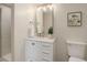 Freshly remodeled bathroom with modern fixtures, stylish vanity, and elegant framed mirror at 2635 S Lamar Way, Lakewood, CO 80227