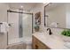 Bathroom featuring a modern vanity, shower with glass door and gray and white tiling at 2635 S Lamar Way, Lakewood, CO 80227