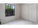 Bedroom with gray walls, white trim, carpet, a window overlooking greenery, and a closet at 2635 S Lamar Way, Lakewood, CO 80227