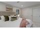 Comfortable bedroom featuring a padded headboard and white sliding-door closet at 2635 S Lamar Way, Lakewood, CO 80227
