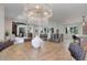 Dining room featuring a decorative chandelier, a large table with woven chairs, and a view to the living room at 2635 S Lamar Way, Lakewood, CO 80227