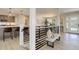 Bright entryway featuring modern railings, a bench, and a view into the kitchen with stylish lighting at 2635 S Lamar Way, Lakewood, CO 80227