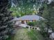 An elevated angle reveals a lush green lawn, mature tree coverage, and a well maintained home at 2635 S Lamar Way, Lakewood, CO 80227