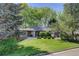 Well-maintained single-story home on a lush green lawn, mature tree coverage, and appealing curb appeal at 2635 S Lamar Way, Lakewood, CO 80227