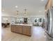 Spacious open-concept kitchen with an island, stainless steel appliances, and an adjacent dining and living area at 2635 S Lamar Way, Lakewood, CO 80227